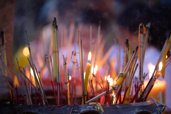 Burning incense sticks in a Buddhist Temple in Thailand.